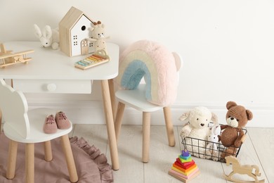 Photo of Different cute toys and furniture in child's room