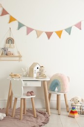Photo of Different cute toys and furniture in child's room
