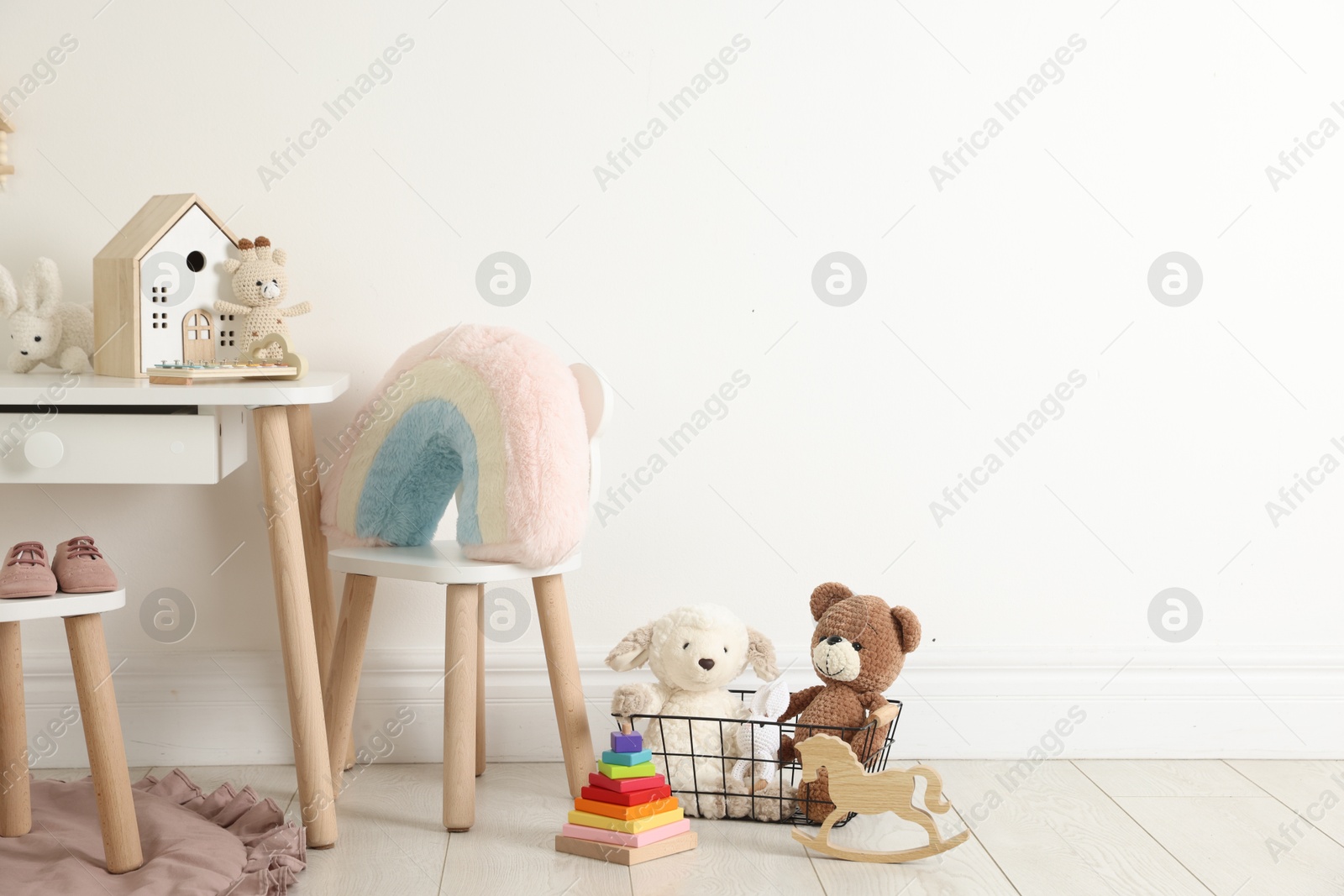 Photo of Different cute toys and furniture in child's room. Space for text