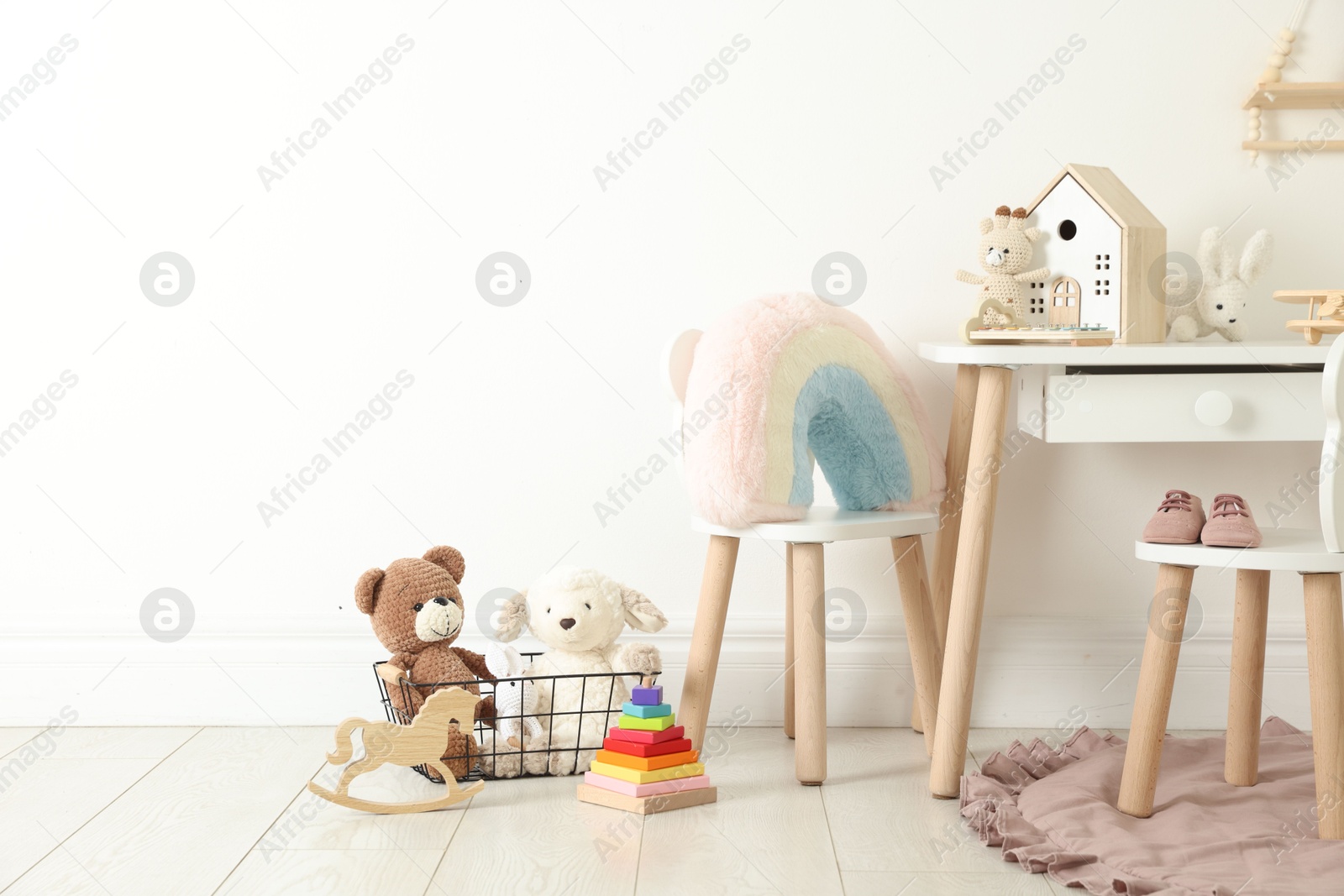Photo of Different cute toys and furniture in child's room. Space for text