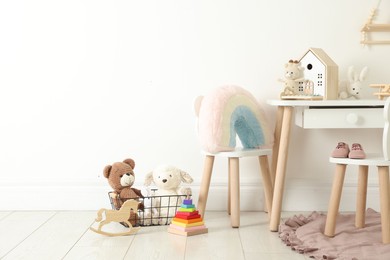 Photo of Different cute toys and furniture in child's room. Space for text