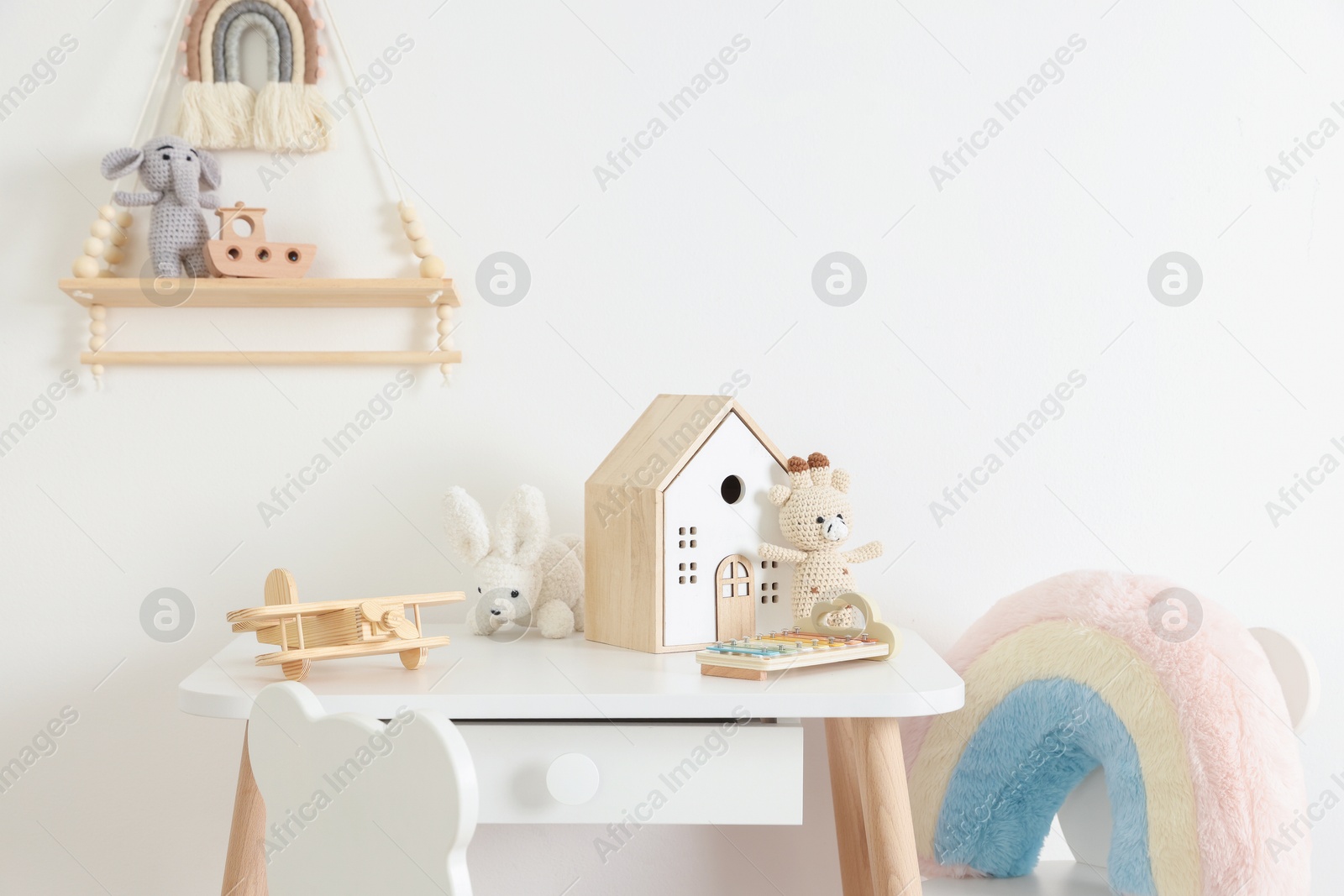 Photo of Different cute toys, table and chair in child's room