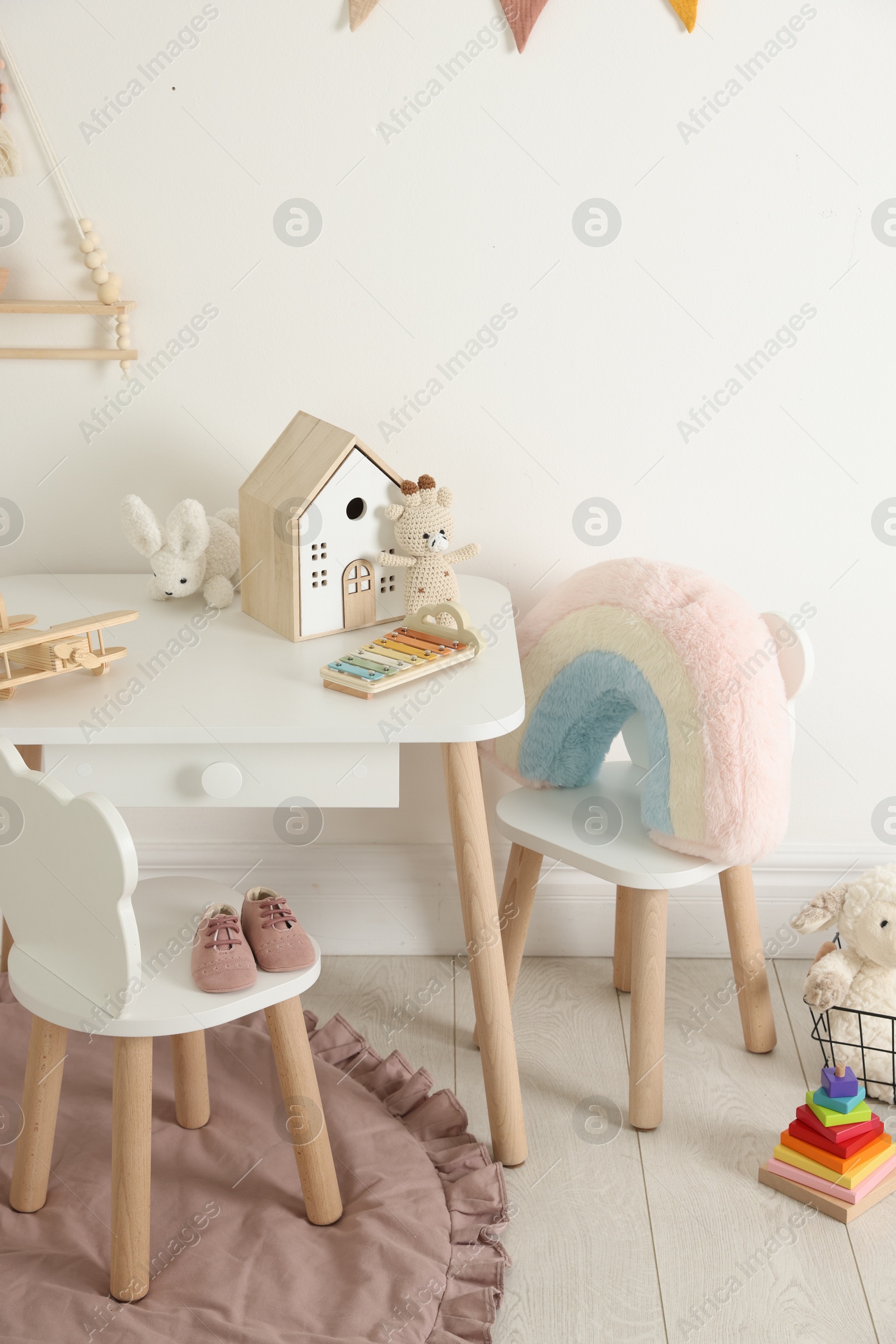 Photo of Different cute toys and furniture in child's room