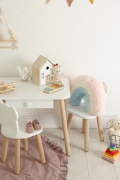 Photo of Different cute toys and furniture in child's room