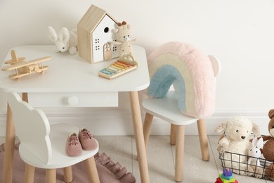 Photo of Different cute toys and furniture in child's room
