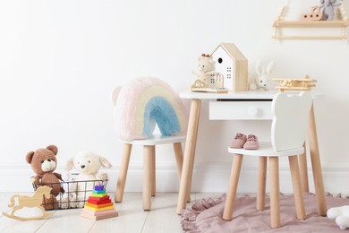 Photo of Different cute toys and furniture in child's room