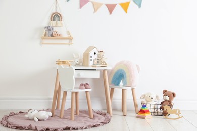Photo of Different cute toys and furniture in child's room