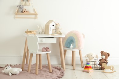 Photo of Different cute toys and furniture in child's room
