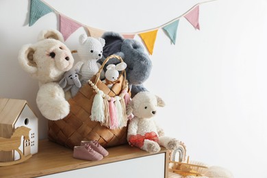 Photo of Different toys on chest of drawers near white wall indoors. Space for text
