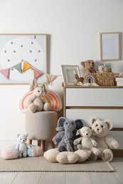 Photo of Different cute toys, furniture and garland in child's room