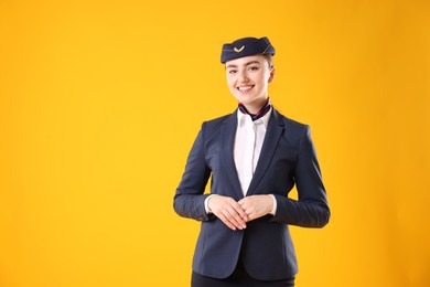Photo of Charming stewardess on yellow background. Space for text
