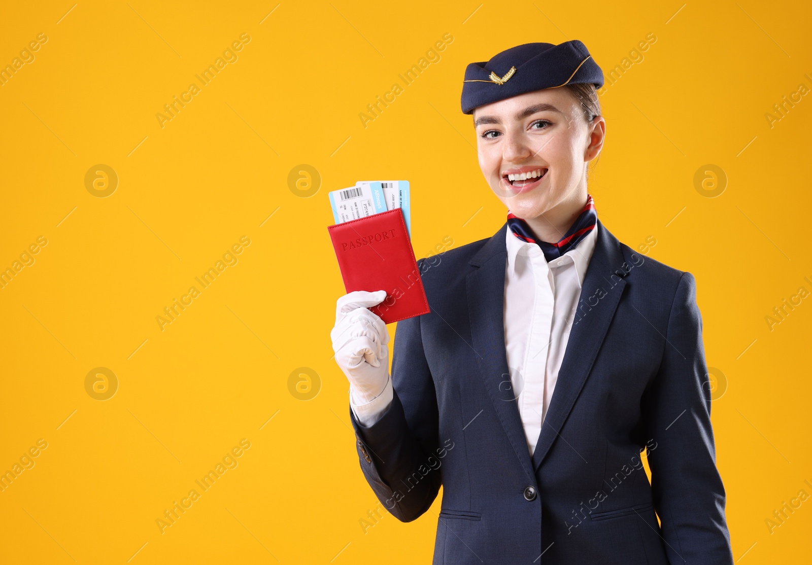 Photo of Smiling stewardess with passport and tickets on yellow background. Space for text