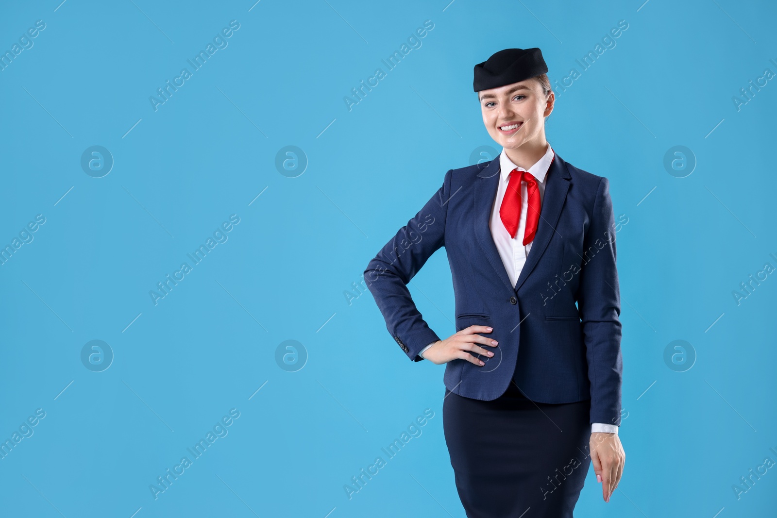 Photo of Charming stewardess in uniform on light blue background. Space for text
