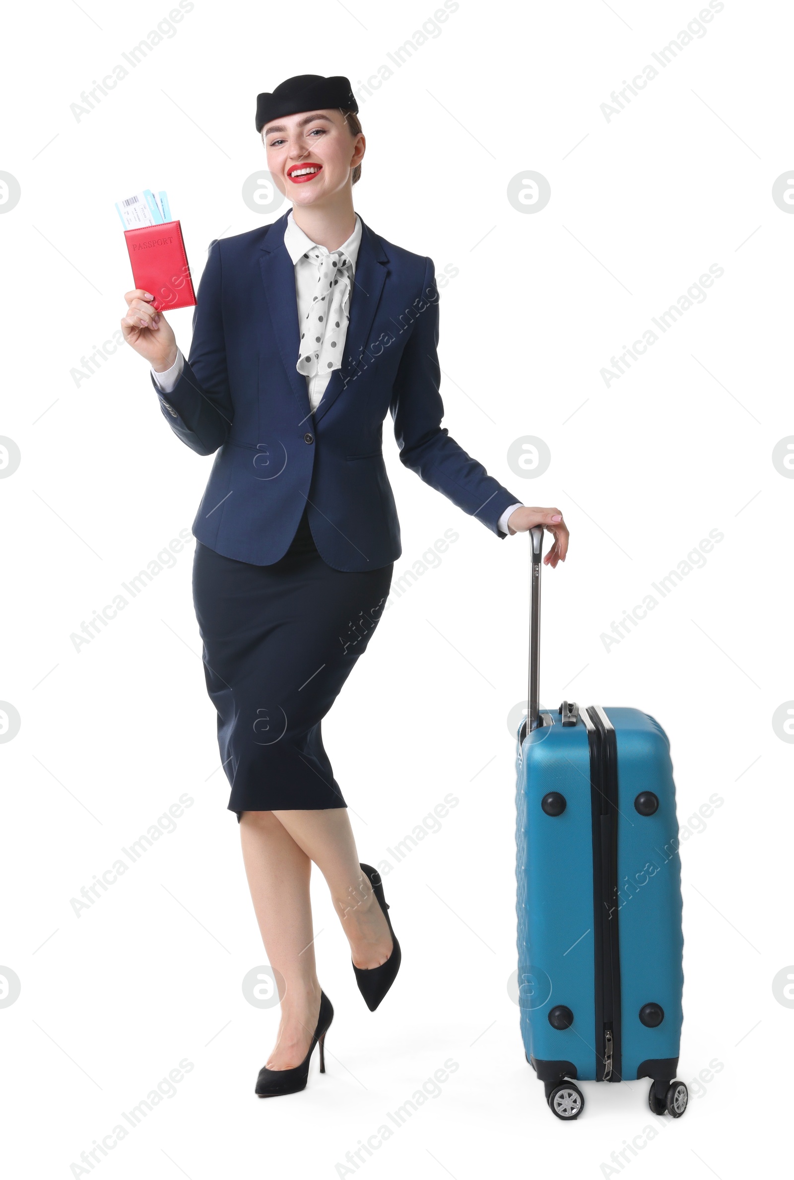 Photo of Positive stewardess with suitcase, passport and tickets on white background