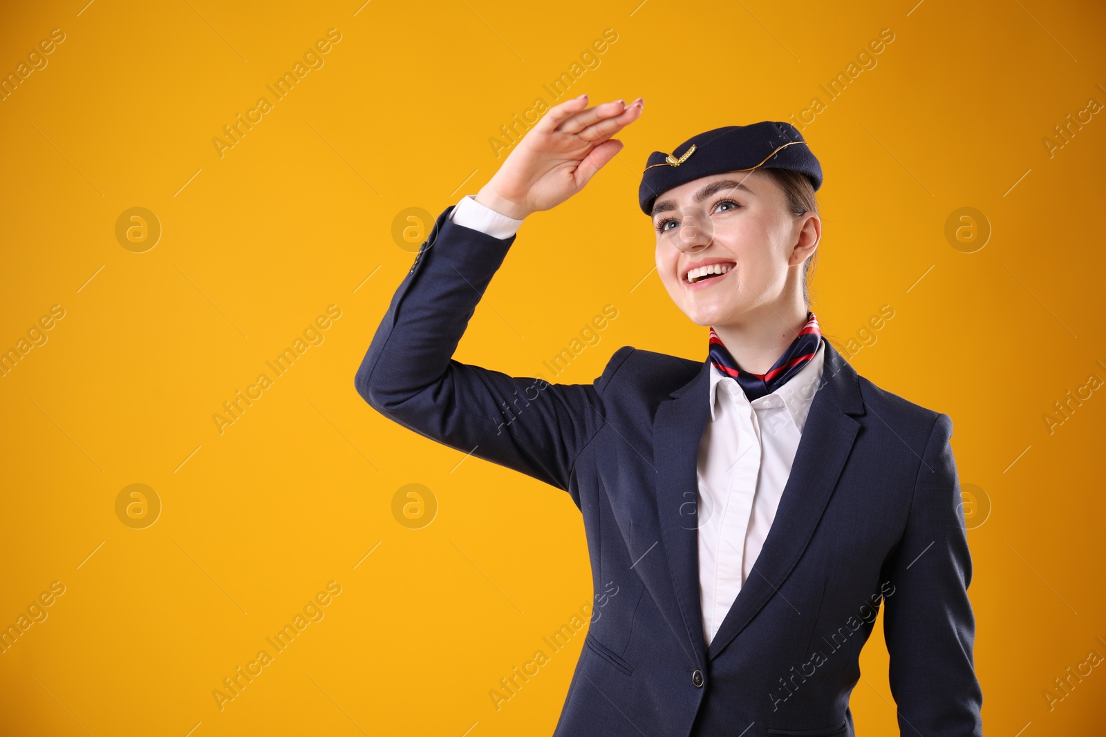 Photo of Charming stewardess in uniform on yellow background. Space for text
