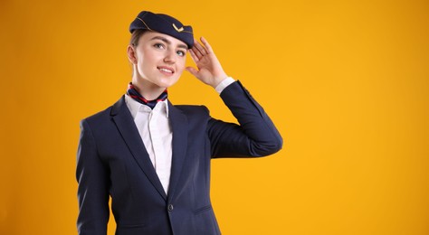 Photo of Charming stewardess in uniform on yellow background. Space for text