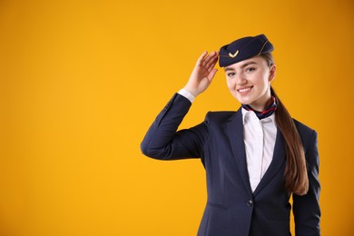 Photo of Charming stewardess in uniform on yellow background. Space for text