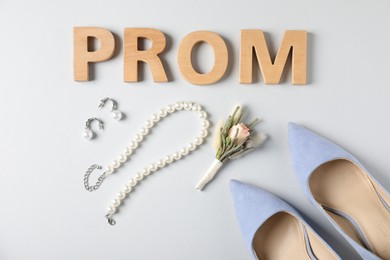 Photo of Flat lay composition with word Prom made of wooden letters, boutonniere and accessories on white background