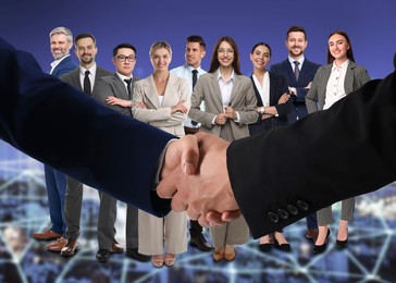 Image of Partners shaking hands against group of business people