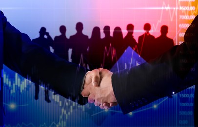 Image of Business partners shaking hands against silhouettes of people