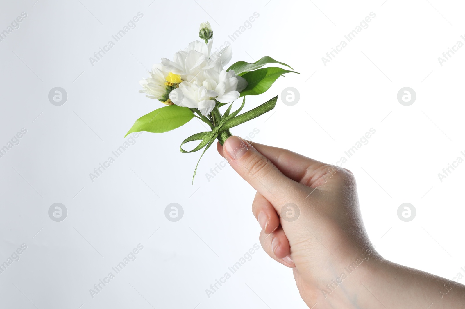 Photo of Woman with beautiful boutonniere on white background, closeup