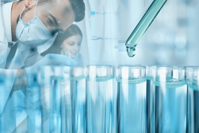 Image of Laboratory analysis. Dripping reagent into test tube, double exposure with scientists