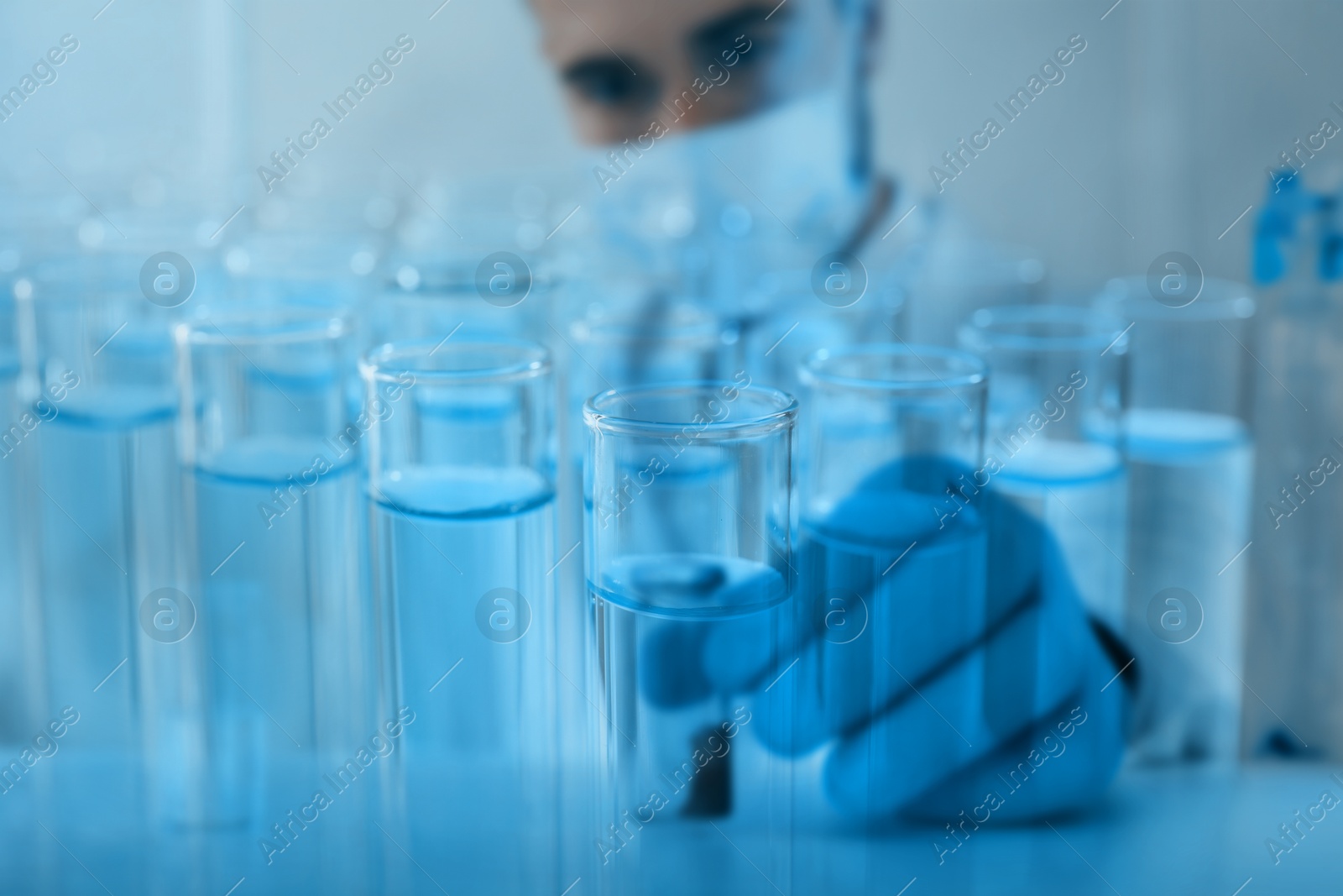 Image of Laboratory analysis. Many test tubes, double exposure with scientist