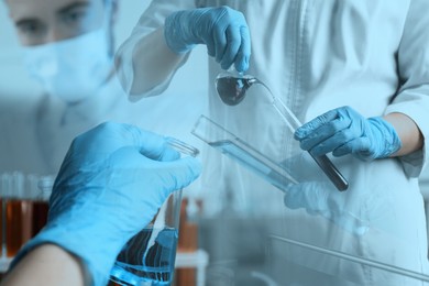 Image of Laboratory analysis. Scientists working with glassware, multiple exposure