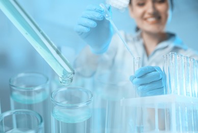 Image of Laboratory analysis. Scientist working with sample, double exposure with test tubes