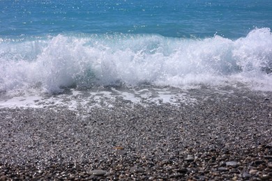 Photo of Beautiful view of wavy sea and pebbles on beach