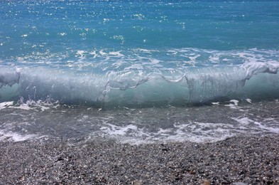 Photo of Beautiful view of wavy sea and pebbles on beach