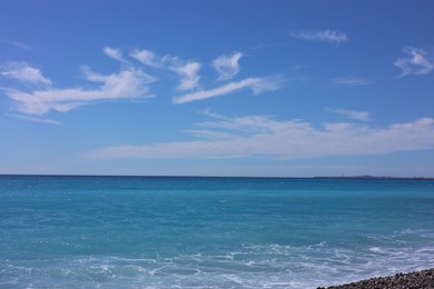 Photo of Beautiful view of wavy sea and pebbles on beach