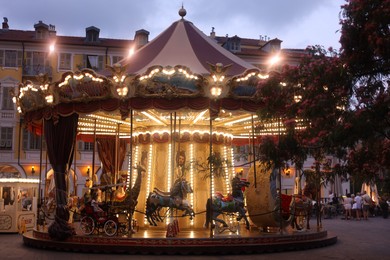 Photo of Nice, France - August 24, 2025: Beautiful illuminated carousel in amusement park
