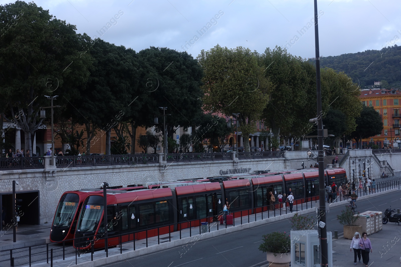 Photo of Nice, France - August 24, 2025: Picturesque view of tram, buildings and trees in city