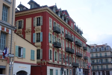 Photo of Nice, France - August 24, 2025: Beautiful buildings with windows in city, low angle view