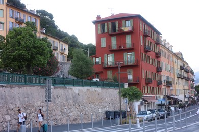 Photo of Nice, France - August 24, 2025: Picturesque view of buildings, road and parked cars in city