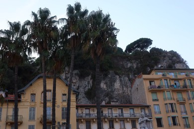 Photo of Nice, France - August 24, 2025: Beautiful building with windows and trees in city, low angle view