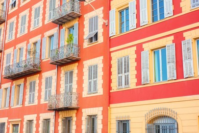 Photo of Beautiful building with windows and balconies in city, low angle view
