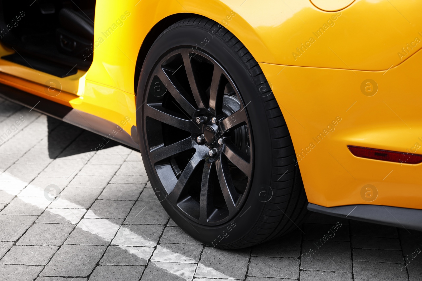 Photo of Modern cabriolet parked on parking lot outdoors, closeup