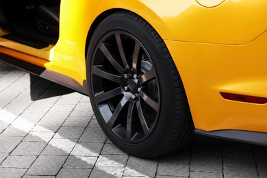 Photo of Modern cabriolet parked on parking lot outdoors, closeup