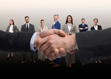 Image of Partners shaking hands against group of business people