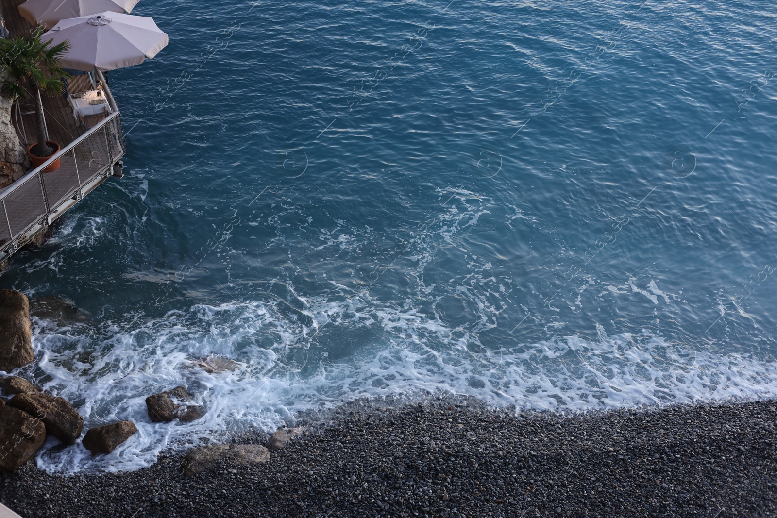 Photo of Seaside restaurant on cliff over beautiful sea, above view