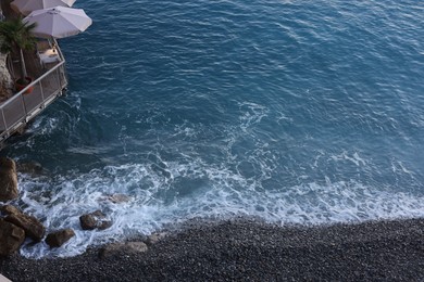 Photo of Seaside restaurant on cliff over beautiful sea, above view