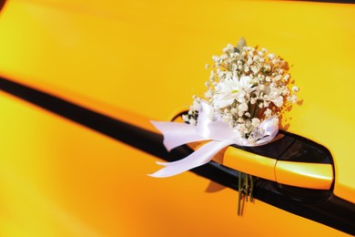 Photo of Wedding car. Closeup view of cabriolet decorated with beautiful flowers