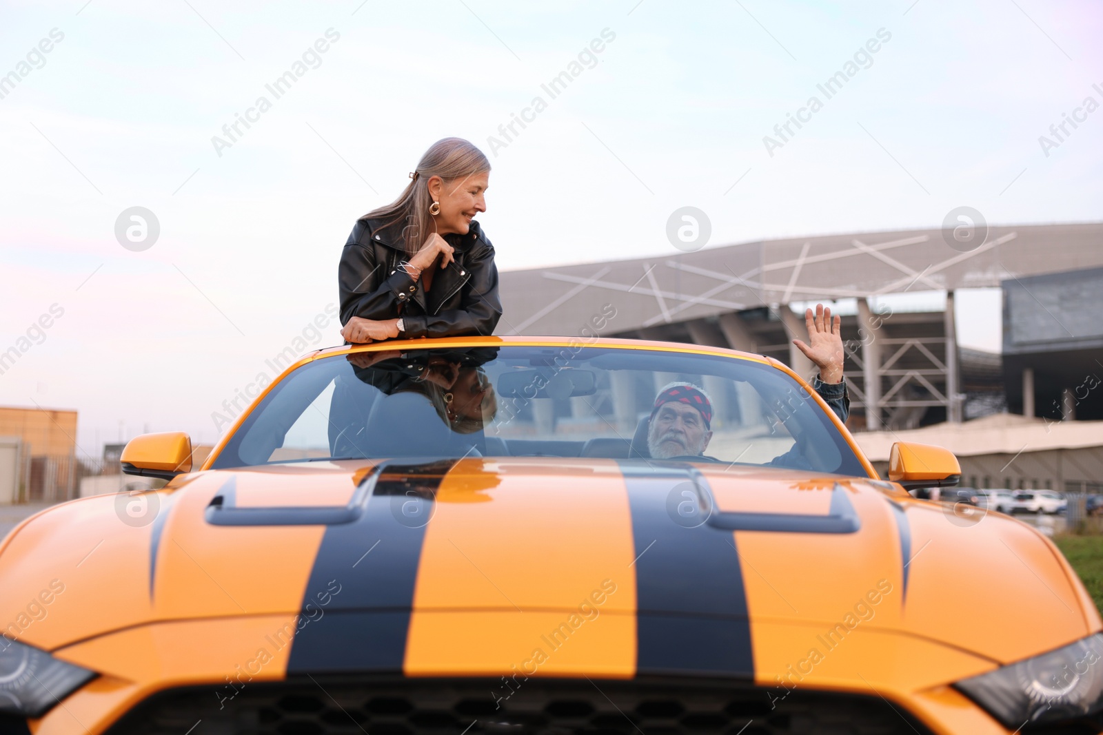 Photo of Senior couple enjoying cabriolet ride in city