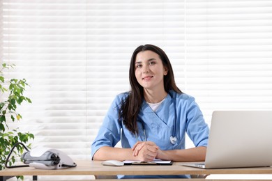 Photo of Portrait of nurse at wooden table in clinic