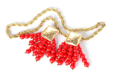 Photo of Stylish gold earrings and necklace isolated on white