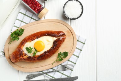 Photo of Tasty khachapuri with cheese and egg served on white wooden table, flat lay. Space for text