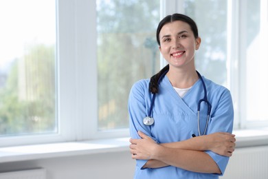 Photo of Nurse with stethoscope near window in clinic, space for text