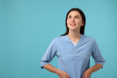 Photo of Nurse in uniform on light blue background, space for text